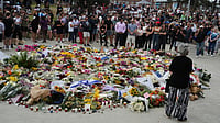 AP : People gather at a growing flower memorial to shooting victims outside the Bondi Pavilion at Sydney's Bondi Beach.
