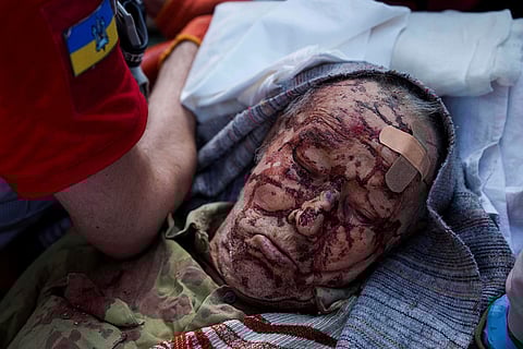 Red Cross volunteers evacuate an injured person from a multi-storey residential house destroyed by a Russian strike in Kyiv, Ukraine, June 17, 2025. 
