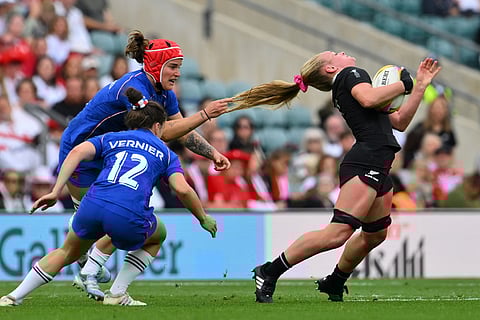 New Zealand's Jorja Miller gets her hair pulled by Charlotte Escudero of France during the Women's Rugby World Cup bronze match between New Zealand and France at the Allianz Stadium, Twickenham, London, Sept. 27, 2025. 