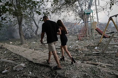 Residents pass by the site of a Russian air strike which destroyed a residential house in Kramatorsk, Ukraine, July 31, 2025. 