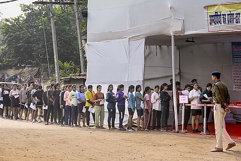 Aspirants wait in a queue before appearing for the Central Selection Board (Constable Recruitment) physical efficiency test, in Patna.