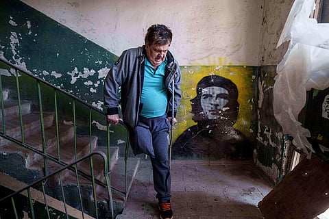 Mykhailo Maistruk, 67, walks downstairs during an evacuation from Kostiantynivka, Ukraine, Sept. 2, 2025. 