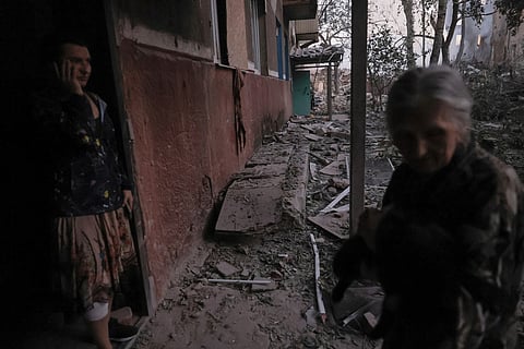 Local people react after a residential building was destroyed by a Russian air strike in Kramatorsk, Ukraine, July 31, 2025. 