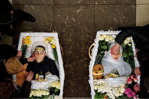 Mothers cry over the coffins of their children Danylo Nikittskyi, 15, and Alina Kutsenko, 15, killed by a Russian missile, during a funeral ceremony in Kryvyi Rih, Ukraine, April 7, 2025. 