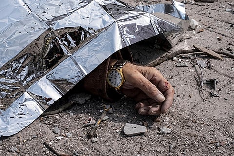 A dead body lies on the ground after a Russian missile strike in Sumy, Ukraine, April 13, 2025. 