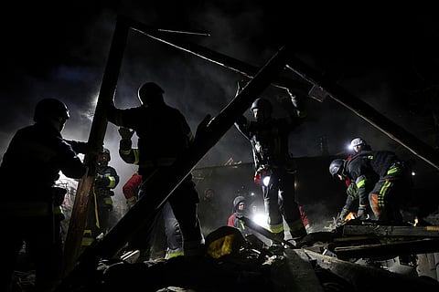 Rescue workers clear the rubble of a residential house destroyed by a Russian drone strike in Zaporizhzhia, Ukraine, March 21, 2025. 
