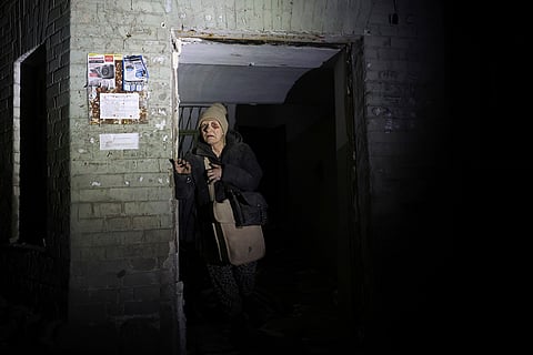 An elderly woman leaves her damaged home after a missile attack in Zaporizhzhia, Ukraine, Jan. 23, 2025. 