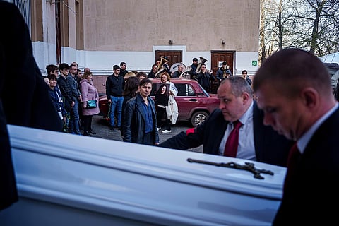 Funeral workers carry the coffin of Olena Kohut, an orchestra musician who was killed in a deadly Palm Sunday Russian attack on Sumy on April 13, during a farewell ceremony in Sumy, Ukraine, April 15, 2025. 