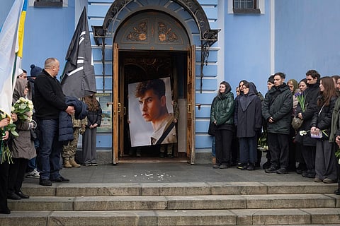 Servicemen carry a portrait of volunteer soldier Volodymyr Rakov, 30, a well known dancer and choreographer, who was killed during the Russia Ukraine war, during the farewell ceremony at St.Michael Cathedral in Kyiv, Ukraine, March 2, 2025. 