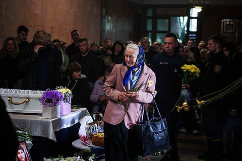 A woman cries during a funeral ceremony for Tamara Martyniuk, 8, Stanislav Martyniuk, 12, and Roman Martyniuk, 17, killed in a Russian strike in Korostyshiv, Zhytomyr region, Ukraine, May 28, 2025. 