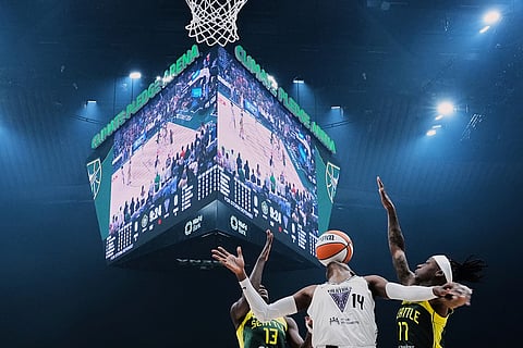 Golden State Valkyries center Temi Fagbenle (14) loses the ball against Seattle Storm forward Ezi Magbegor (13) and guard Erica Wheeler, right, during the first half of a WNBA basketball game, July 16, 2025, in Seattle. 