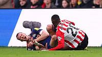 Newcastle defender Dan Burn is injured in a tackle with Nordi Mukiele