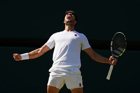 Carlos Alcaraz of Spain celebrates winning the men's semifinal singles match against Taylor Fritz of the U.S. at the Wimbledon Tennis Championships in London, July 11, 2025.