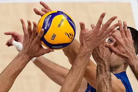 Pavle Peric of Serbia is blocked by Iran players during a round of 16 match at the 2025 FIVB Volleyball Men's World Championship at the Mall of Asia Arena in Pasay city, Philippines, Sept. 23, 2025. 
