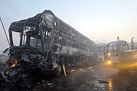 Fog Triggers Deadly Multi-Vehicle Pile-Up on Yamuna Expressway | Photo: PTI : Cranes clear the charred remains of buses after a fog-hit pile-up involving several buses and cars triggered fires on the Yamuna Expressway, in Mathura.
