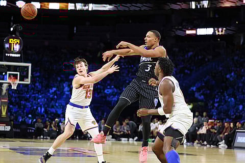 Orlando Magic guard Desmond Bane (3) passes the ball between New York Knicks' Tyler Kolek (13) and Og Anunoby (8) in the second half of an NBA Cup semifinals basketball game in Las Vegas.