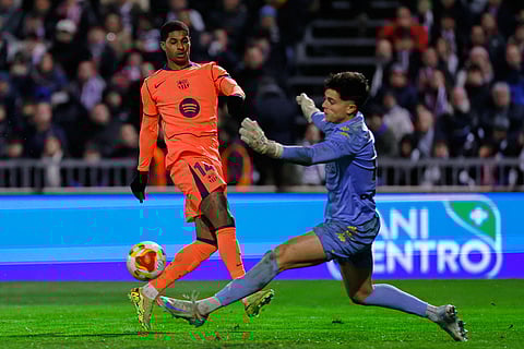 Barcelona's Marcus Rashford, left, fights for the ball with Guadalajara's goalkeeper Dani Vicente during the Copa del Rey soccer match between Guadalajara and Barcelona in Guadalajara, Spain.
