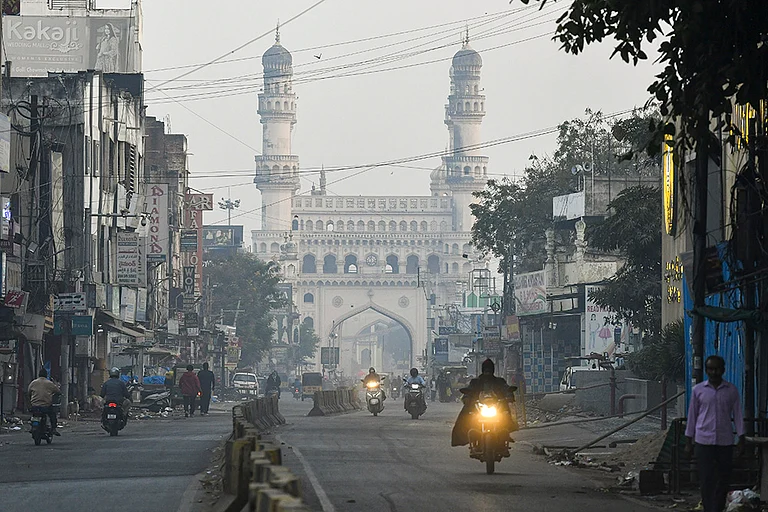 Commuters on a foggy winter morning near the Charminar, in the Old City of Hyderabad, Telangana. - | Photo: PTI