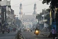 | Photo: PTI : Commuters on a foggy winter morning near the Charminar, in the Old City of Hyderabad, Telangana.