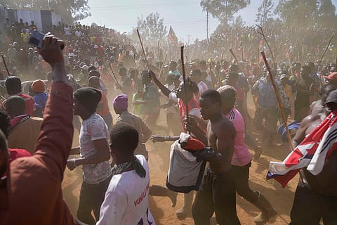 A crowd of spectators dances and sings after bull Shakahola won bullfighting match, in Kakamega, Kenya.