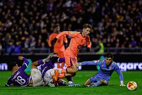 Barcelona's Fermin Lopez, center, tries a shot next to Guadalajara's Dani Vicente during the Copa del Rey soccer match between Guadalajara and Barcelona in Guadalajara, Spain.