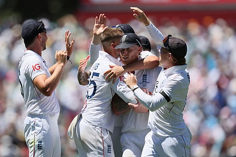 England's Will Jacks, second from left, and England's captain Ben Stokes celebrates the wicket of Australia's Usman Khawaja during play on day one of the third Ashes cricket test between England and Australia at the Adelaide Oval in Adelaide, Australia.