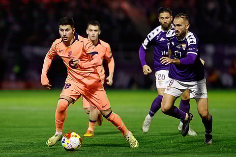Barcelona's Roony Bardghji, left, vies for the ball with Guadalajara's Alejandro Canizo during the Copa del Rey soccer match between Guadalajara and Barcelona in Guadalajara, Spain.