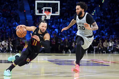 New York Knicks guard Jalen Brunson (11) drives against San Antonio Spurs forward Julian Champagne (30) during the second half of the NBA Cup championship basketball game in Las Vegas.