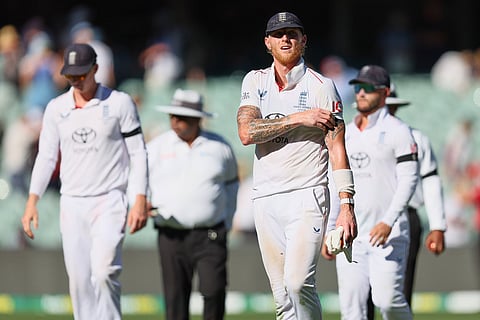 England's captain Ben Stokes, along with his team members, walks back to the pavilion at the end of day one of the third Ashes cricket Test between England and Australia at the Adelaide Oval in Adelaide, Australia.