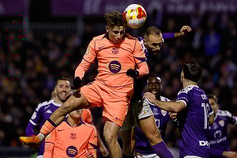 Barcelona's Fermin Lopez, center, heads for the ball during the Copa del Rey soccer match between Guadalajara and Barcelona in Guadalajara, Spain.