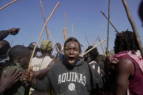 A spectator dances and sings after bull Shakahola won bullfighting match, in Kakamega, Kenya.