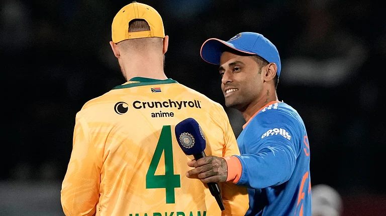 India's captain Suryakumar Yadav talks with South Africa's captain Aiden Markram before the start of their third T20I match on December 14, 2025. - | Photo: AP/Ashwini Bhatia