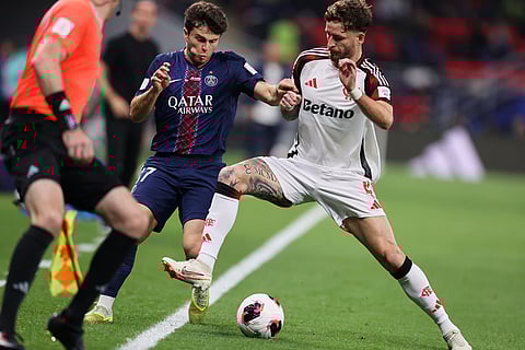 PSG's Joao Neves, left, fights for the ball with Flamengo's Leo Pereira during the FIFA Intercontinental Cup final soccer match between Flamengo and Paris Saint-Germain in Doha, Qatar.