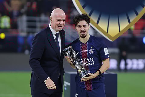 PSG's Vitinha, right, received the best player trophy from FIFA President Gianni Infantino end of the FIFA Intercontinental Cup final soccer match between Flamengo and Paris Saint-Germain in Doha, Qatar.