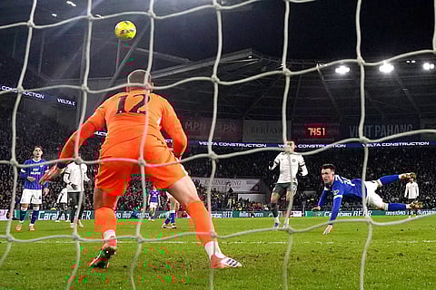 Cardiff City's David Turnbull, right, scores their side's first goal of the game against Chelsea during the English League Cup quarterfinal soccer match in Cardiff.