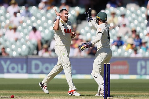 Australia's Scott Boland, left, and Australia's Alex Carey celebrates the wicket of England's Brydon Carse during play on day two of the third Ashes cricket test between England and Australia in Adelaide, Australia.