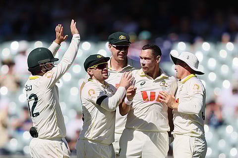 Australia's Scott Boland, second from right, celebrates the wicket of England's Brydon Carse with his teammates during play on day two of the third Ashes cricket test between England and Australia in Adelaide, Australia.