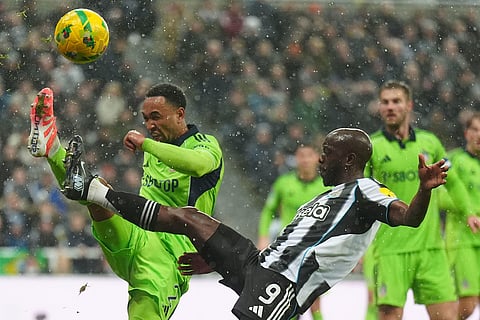 Fulham's Kenny Tete, left, and Newcastle United's Yoane Wissa battle for the ball during the English League Cup quarterfinal soccer match between Newcastle and Fulham in Newcastle upon Tyne, England.