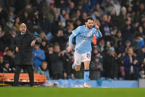 Manchester City's Bernardo Silva gestures as he comes on the pitch during the English League Cup soccer match between Manchester City and Brentford in Manchester, England.
