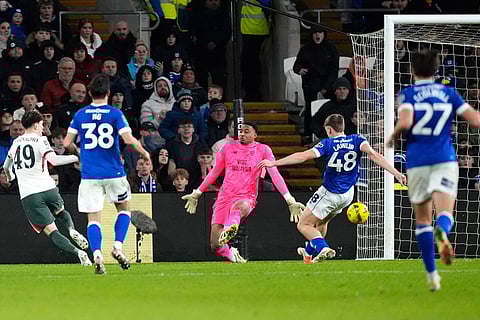 Chelsea's Alejandro Garnacho, left, scores their first goal of the game against Cardiff City during the English League Cup quarterfinal soccer match in Cardiff.