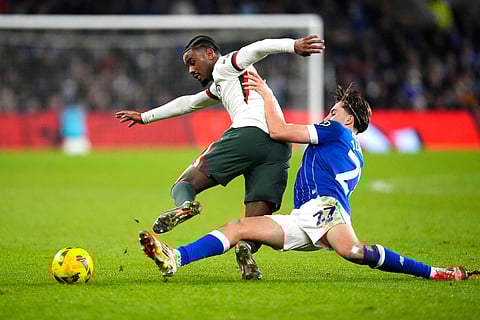 Cardiff City's Joel Colwill, right, tackles Chelsea's Jorrel Hato during the English League Cup quarterfinal soccer match in Cardiff.