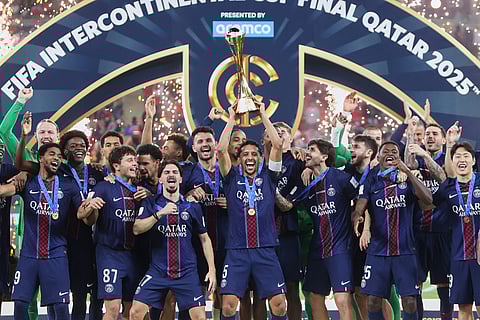 PSG's Marquinhos lifts the trophy after winning the FIFA Intercontinental Cup final soccer match between Flamengo and Paris Saint-Germain in Doha, Qatar.