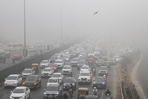 Vehicles move through traffic congestion along the Delhi-Gurugram Expressway on a foggy winter morning, in Gurugram.