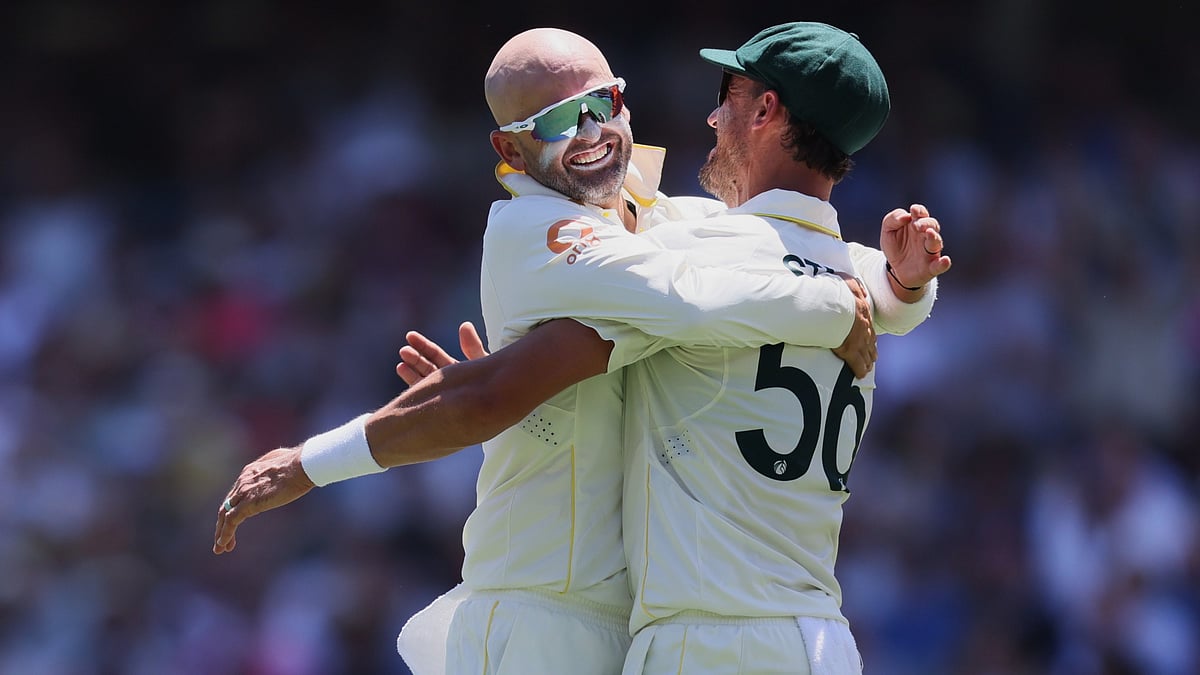  Nathan Lyon, left, celebrates with teammate Mitchell Starc after dismissing England's Ben Duckett. - AP
