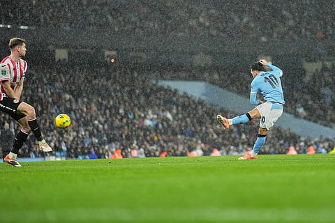 Manchester City's Rayan Cherki scores his side's first goal during the English League Cup soccer match between Manchester City and Brentford in Manchester, England.