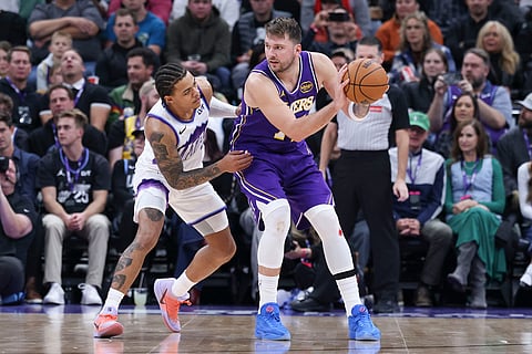 Los Angeles Lakers guard Luka Doncic (77) posts up against Utah Jazz guard Keyonte George, left, during the second half of an NBA basketball game in Salt Lake City. 