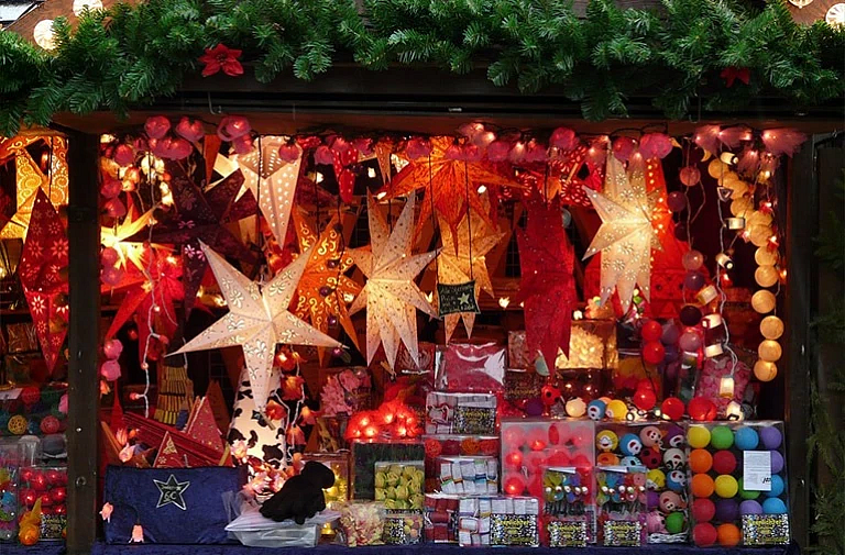 Festive market stall with glowing star lanterns & colorful decorations