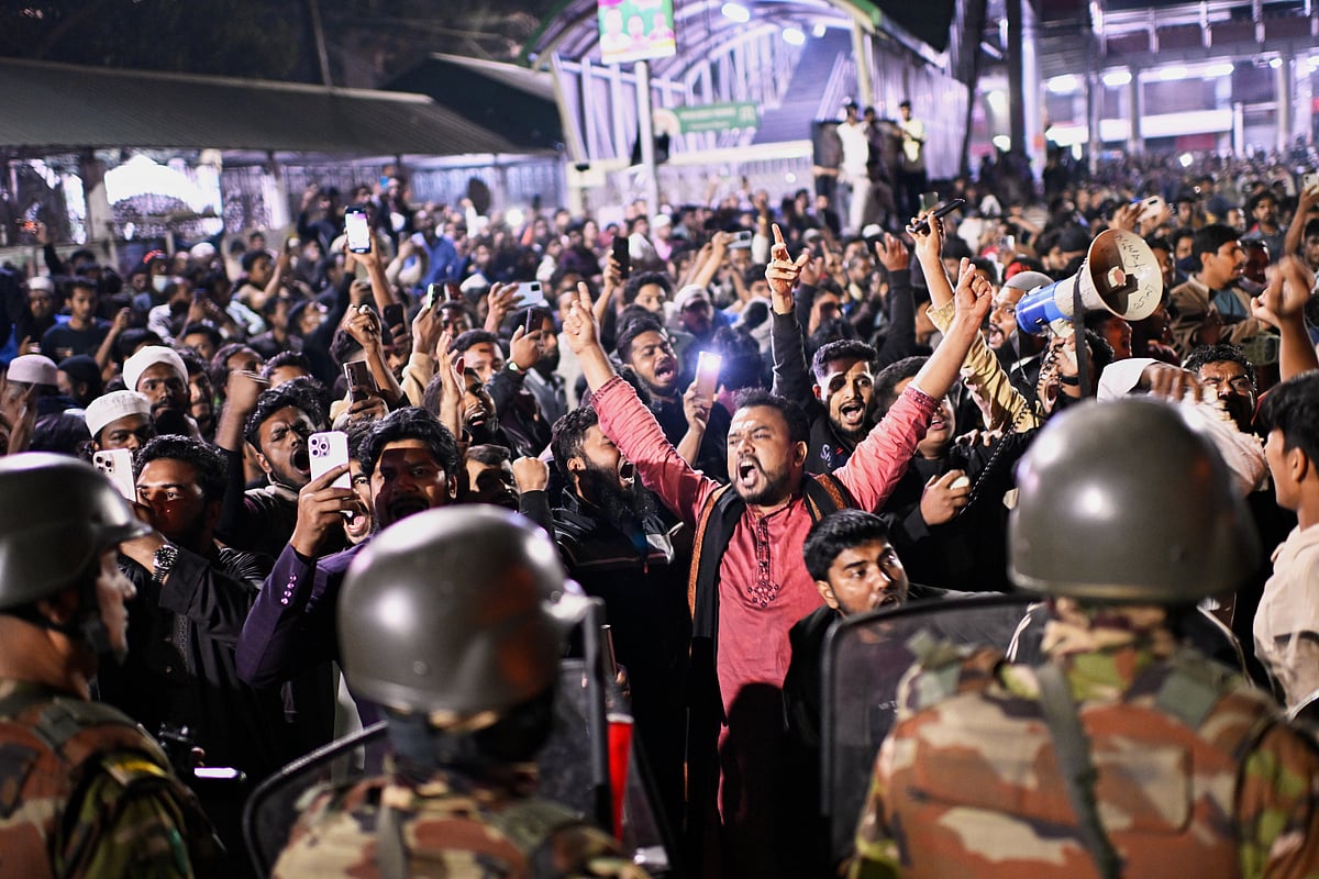 Protesters shout slogans in front of the premises of the Prothom Alo daily newspaper after news reached the country from Singapore of the death of a prominent activist Sharif Osman Hadi, in Dhaka, Bangladesh, Friday, Dec. 19, 2025.  - AP Photo/Mahmud Hossain Opu