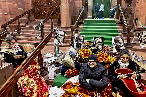 TMC MPs Dola Sen, Ritabrata Banerjee and Sagarika Ghose and other opposition members stage a dharna at the Parliament House complex, amid the ongoing Winter session of Parliament, in New Delhi. Opposition leaders staged a 12-hour overnight protest dharna in the complex on Thursday night, while protesting against the passage of the VB-G RAM G bill that seeks to replace the MGNREGA rural employment programme. 