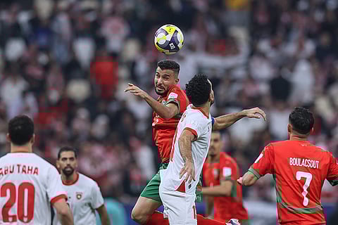 Morocco's Anas Bach, top left, goes for a header with Jordan's Abdallah Nasib during to the FIFA Arab Cup final soccer match between Jordan and Morocco in Lusail, Qatar.